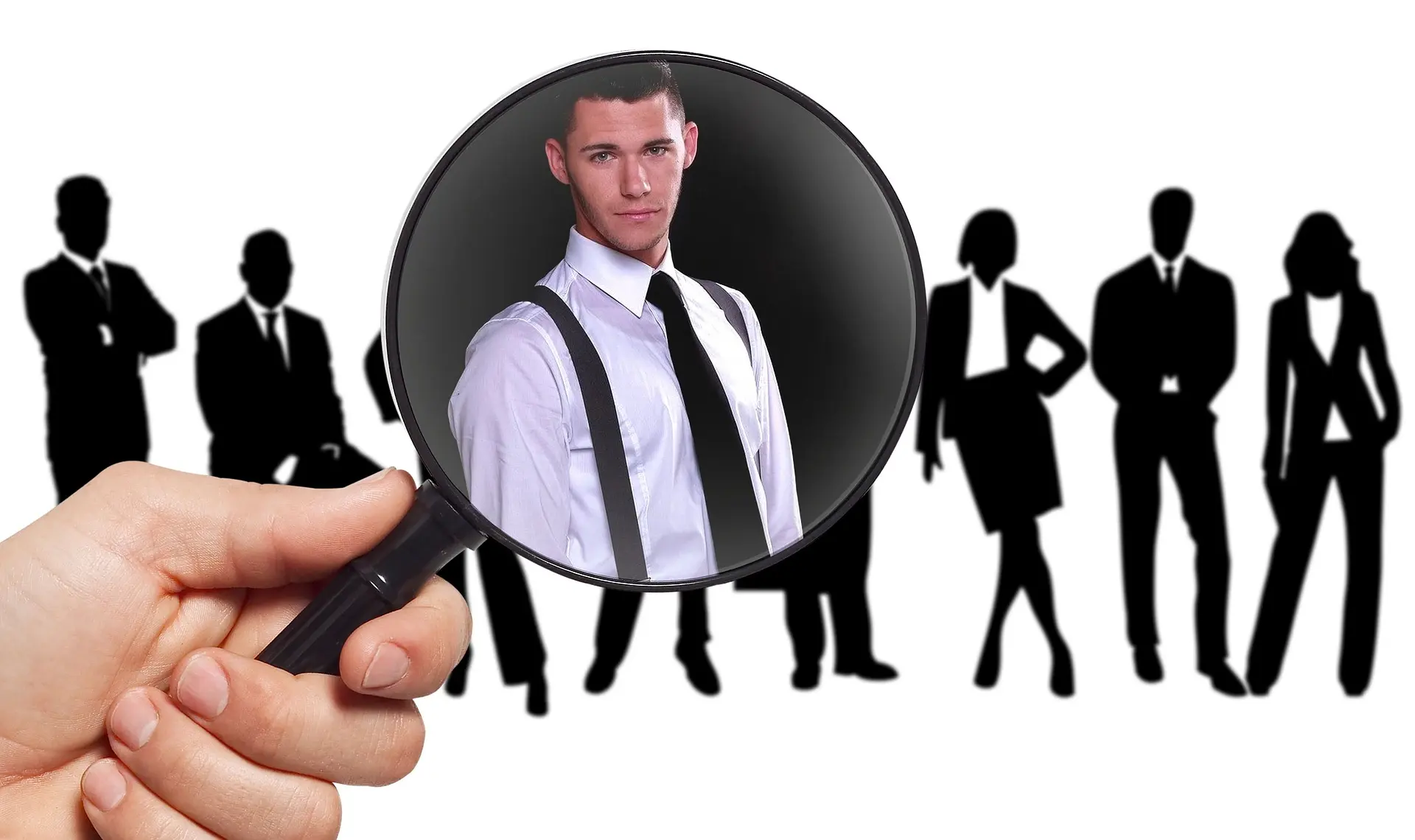 A magnifying glass picks out one candidate from a row of silhouetted professionals